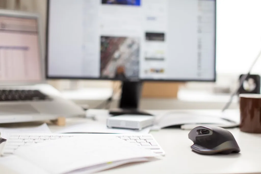 A Quick Look At How Transcribing Services Improve Efficiency And Productivity 1 black flat screen computer monitor and gray wireless mouse