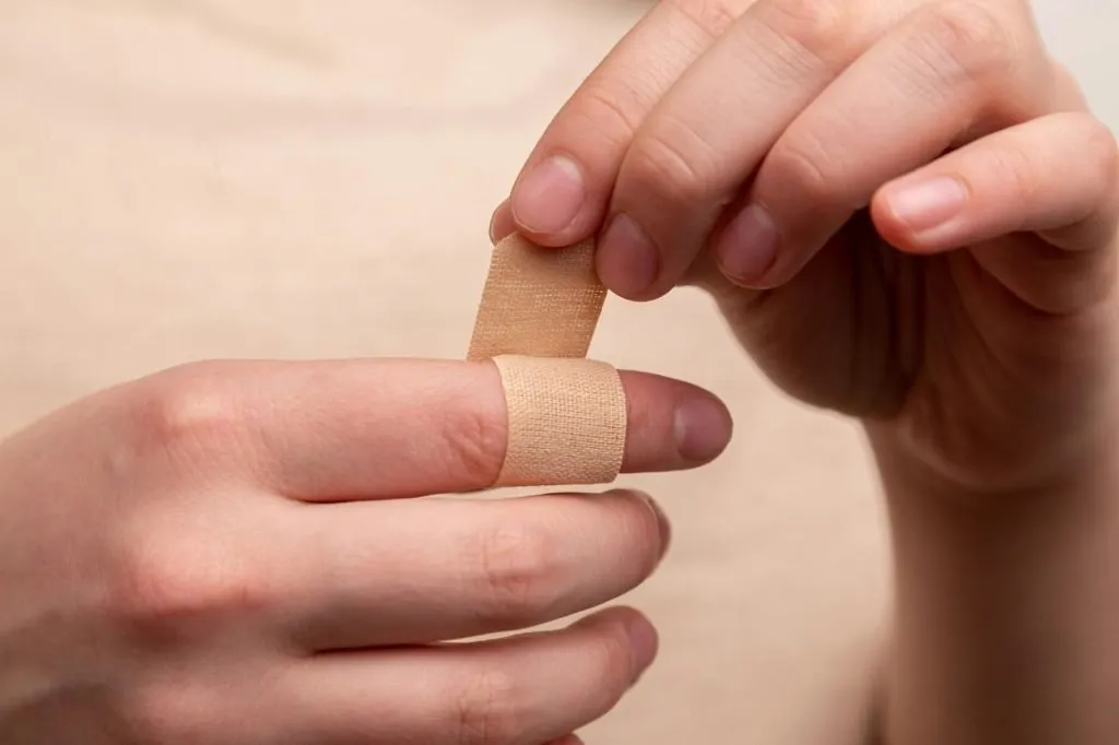 Work Injuries: Proven Ways To Legally Protect Your Rights 1 person with band aid on middle finger