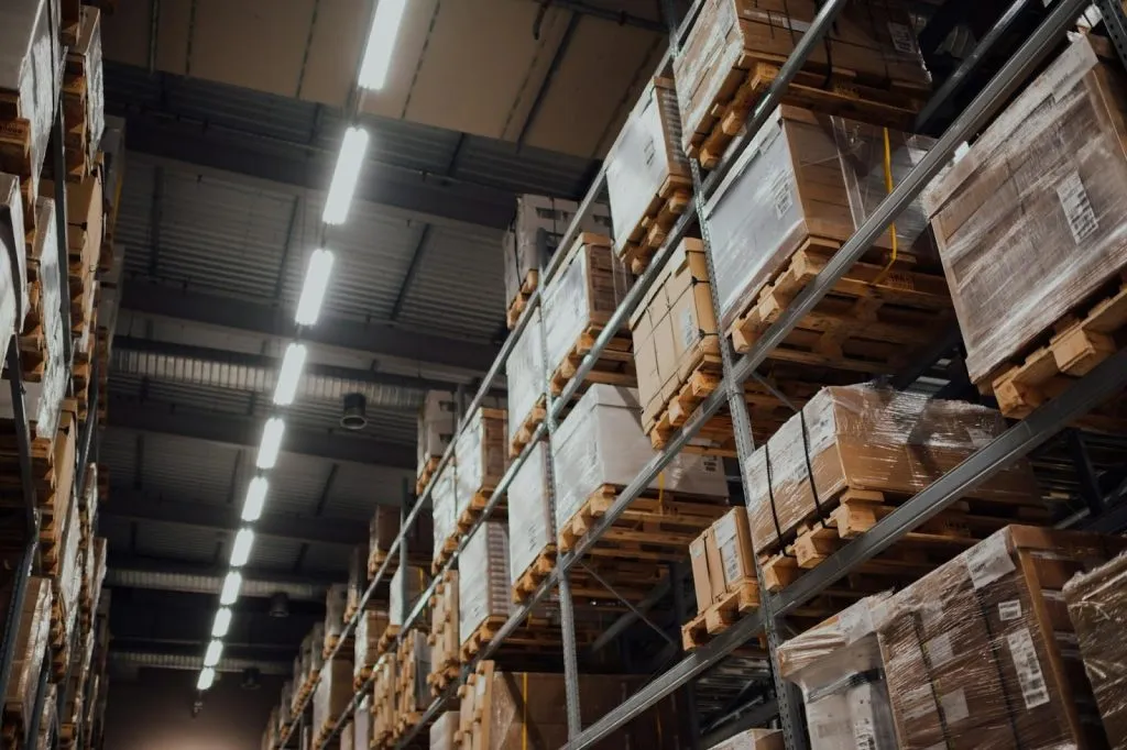 Efficient Warehouse Space Management: Tips And Tricks 3 brown cardboard boxes on white metal rack
