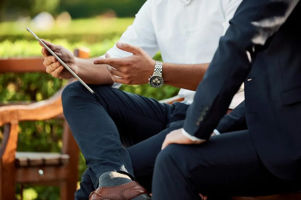 Smart And Simple Decisions That Will Improve Your Business 3 two people sitting one of whom is explaining something using ipad