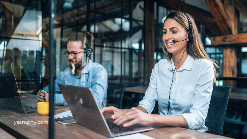 The Power Of Professional Signage Services For Business Growth 3 a woman wearing headphones and using a laptop conotating customer support